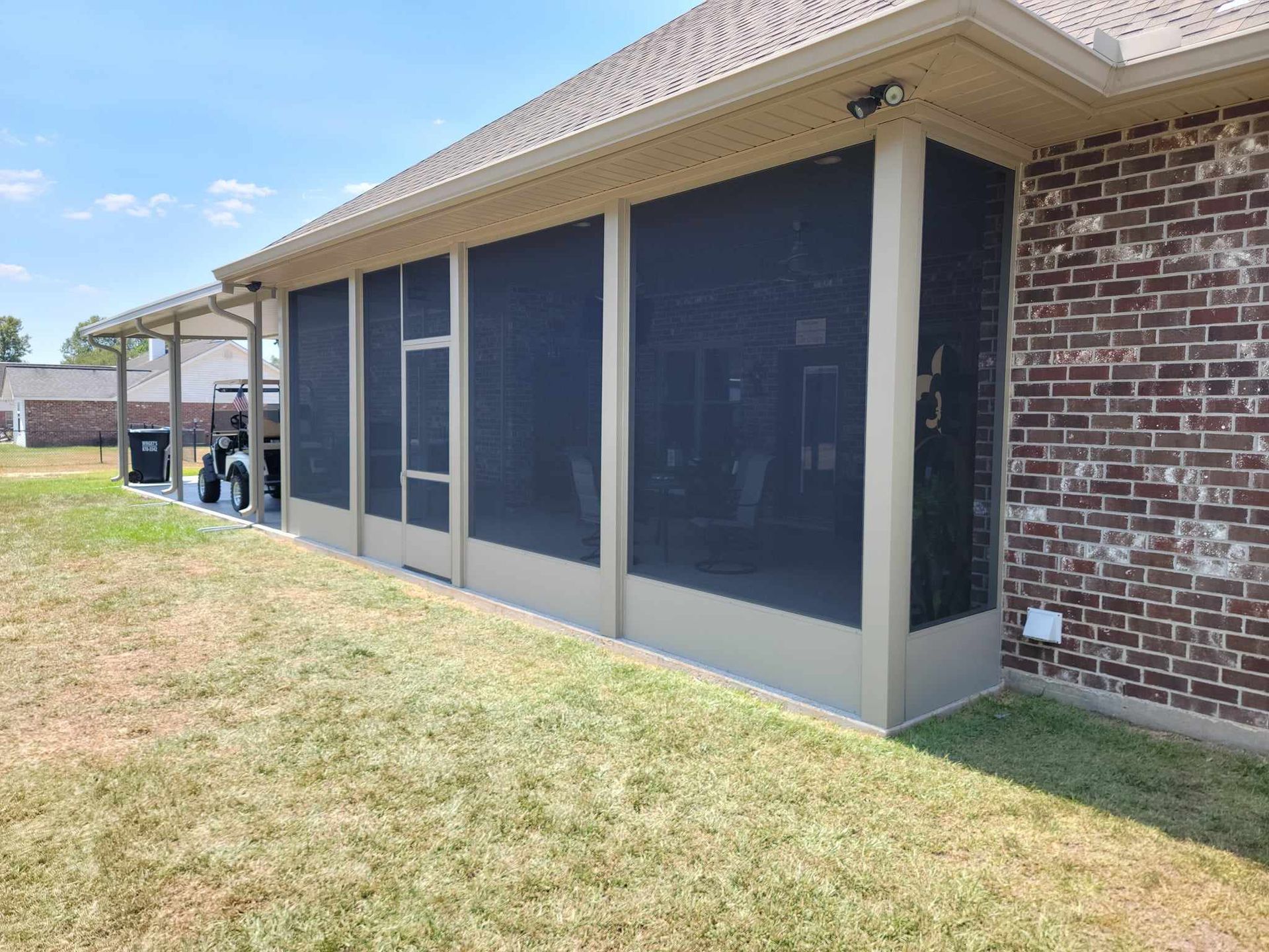 Screen enclosure on a brick home